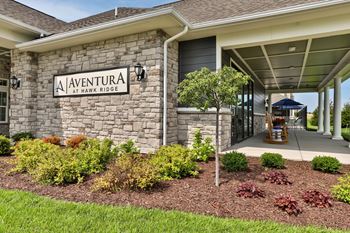 a building with a sign on the front of it  at Aventura at Hawk Ridge, Lake St Louis
